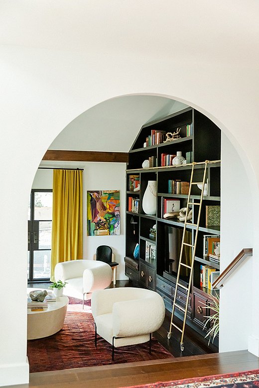 Arched elements throughout the house give it an architectural moral compass, according to Jessie. The formal living room saw the most dramatic change with the introduction of an arched doorway and the built-in bookcase.
