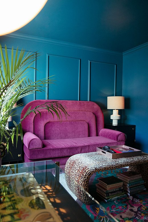 The purple sofa is Jessie’s custom design. Dubbed the ShaSha, it sits in Jessie’s office and transforms into a pull-out bed when guests stay over. Exaggerated arches and a grand silhouette play on the Regency style Jessie incorporated in her design.
