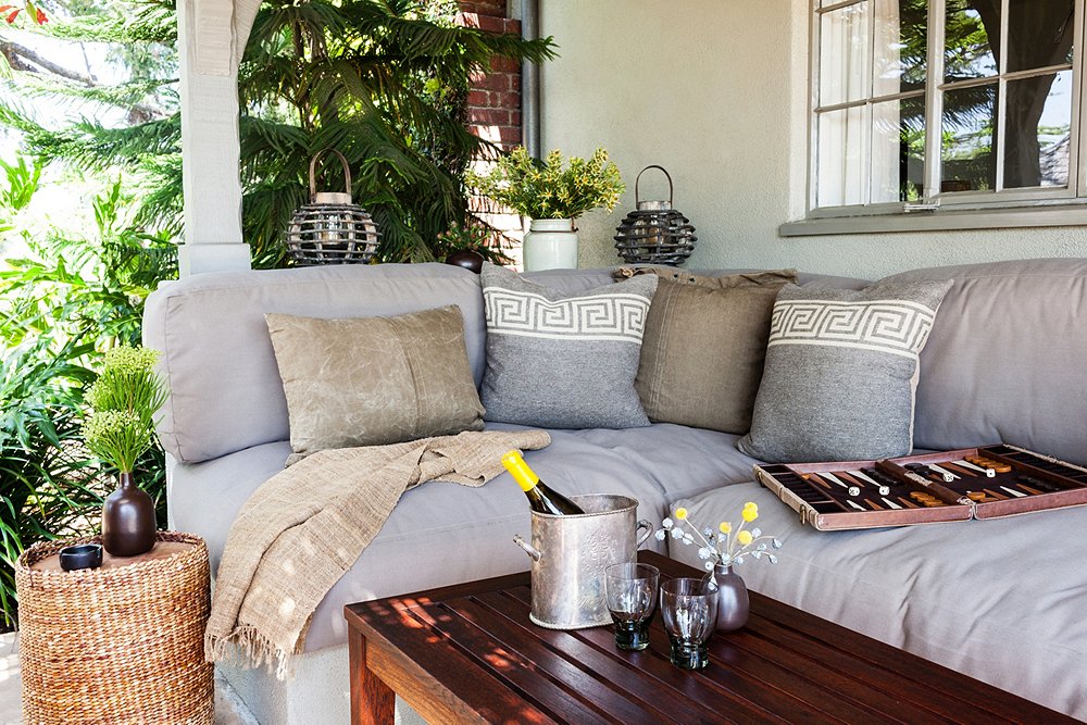 For a versatile look, choose neutral pieces like this gray couch. “I can change the vibe by swapping in sheepskins and funky pillows,” says Stansfield. “If I’m having a Fourth of July party, I can put vintage American flag pillows out and bunting for a completely different look.”
