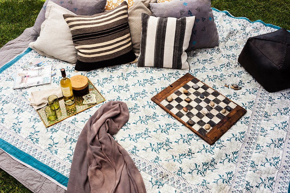 A Roberta Roller Rabbit blanket, layered up with a quilt for a little extra cushion, along with a mix of prettily patterned pillows creates an invitingly chilled-out lounge pad.
