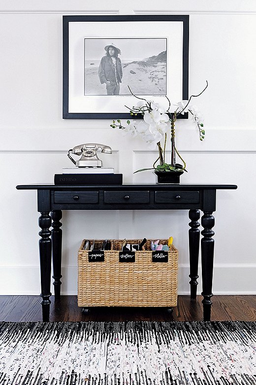 An entry table with three drawers and a labeled basket tucked below make this petite foyer both fabulous and functional.
