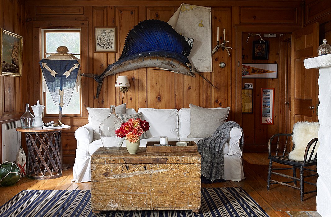 The living room’s preppy mix is anchored by a vintage dhurrie rug (find a similar one here) and a secondhand sailfish. “Good vintage is getting harder and harder to find,” says Matt. “The craft and care that old things were made with is an important thing to have in a home, I think. They just make it feel special.” 
