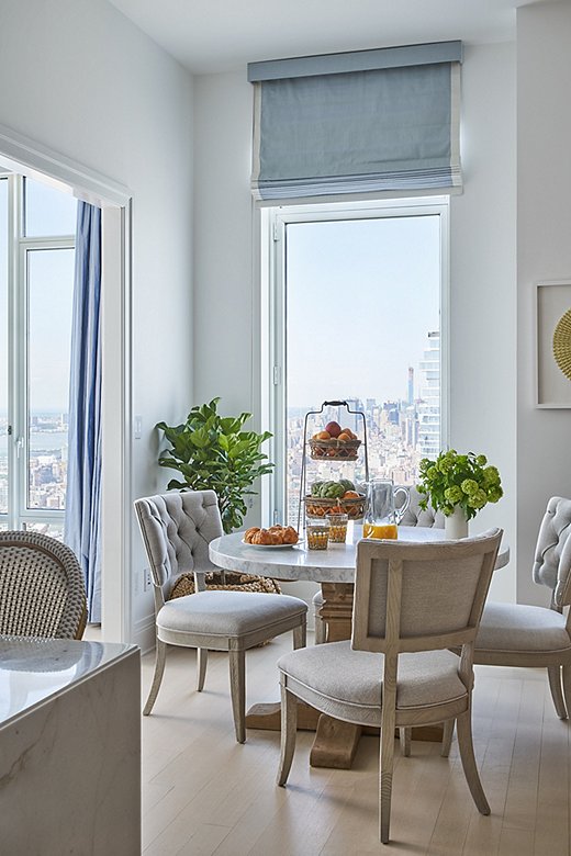 The kitchen features a lovely breakfast nook and seating for four. The tufted side chairs and chic table offer a more casual alternative to the formal dining room.
