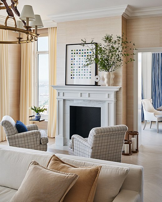 A traditional aesthetic isn’t as constricting as you might think. Ariel opted for this pop of modern art by Dawn Wolfe, a favorite artist of hers, to shake up the feel of the room. “Something super poppy and graphic above the mantel works well because it feels unexpected paired with the men’s suiting fabric on the more traditional club chairs,” Ariel says.
