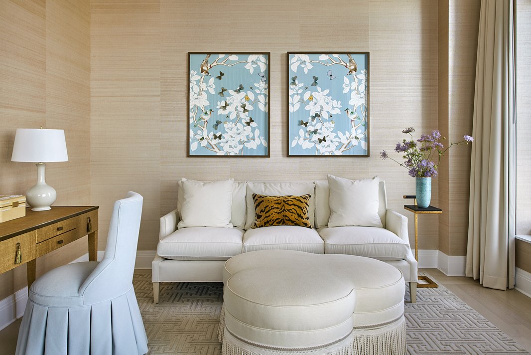 From the ivory settee and ottoman to the graceful art, this room is a picture of serenity. The tiger pillow keeps it from feeling overly sedate, however. Photo by Seth Caplan; room by Ariel Okin.
