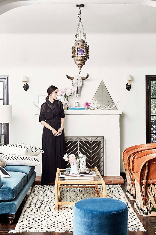 “It’s really a blend of a lot of vibes,” says Tammy of the living room. She pulled in coastal blue velvet upholstery as a nod to Abigail’s childhood in Florida. The mud-cloth pillows and Moroccan rug add a rustic touch to the space.  

