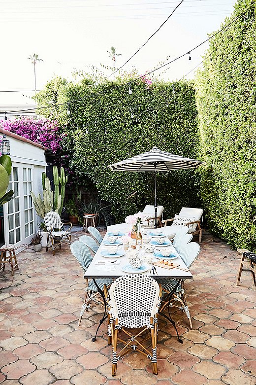 “It’s a pretty amazing space for entertaining,” says Tammy of Abigail’s backyard. She already had the blue and black bistro chairs, so Tammy added benches from Fragments Identity for extra seating.
