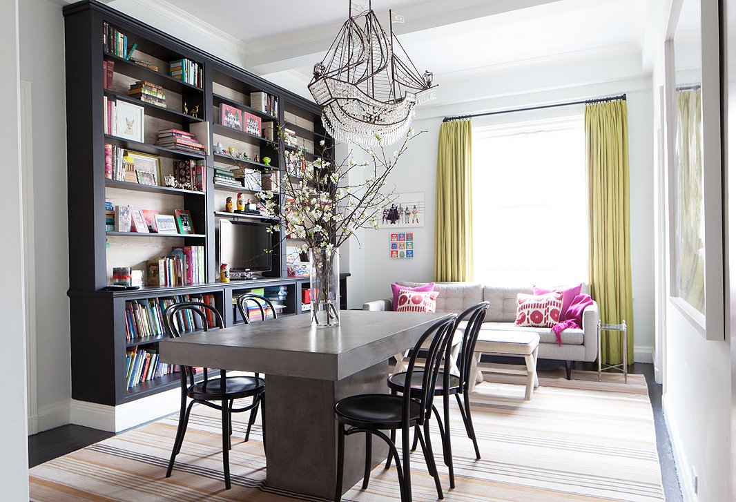 In her multifunctional dining room, Lilly opted for chic comfort—a striped rug is “graphic to hide the stains” and a modern table with a pedestal base is “easy to get around.”
