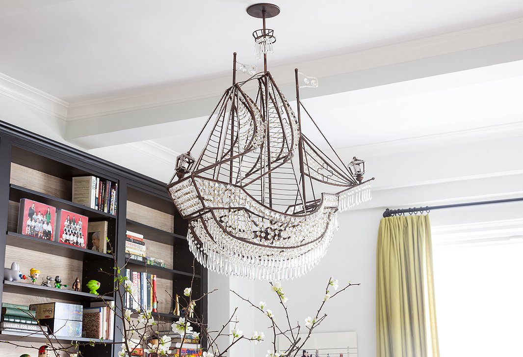 Conjuring up magical feelings of wanderlust, a ship-shaped chandelier, found at a downtown lighting shop, hangs over Lilly’s dining table. “It had been hanging in the store window all winter long, and I kept walking by and staring at it,” she says.
