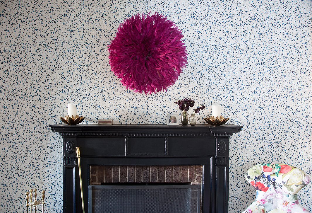 Lilly, who “always” wallpapers hallways, papered the space leading from her living to her dining room with a dotted Hinson design she loves for its handmade look.
