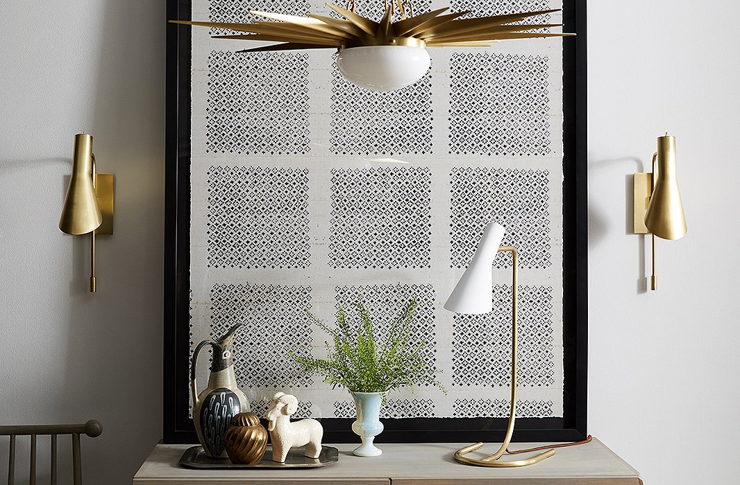 The Penelope Sconce in brass, the Penelope Task Lamp in white, and the Solana Pendant in brass, all by One Kings Lane.

