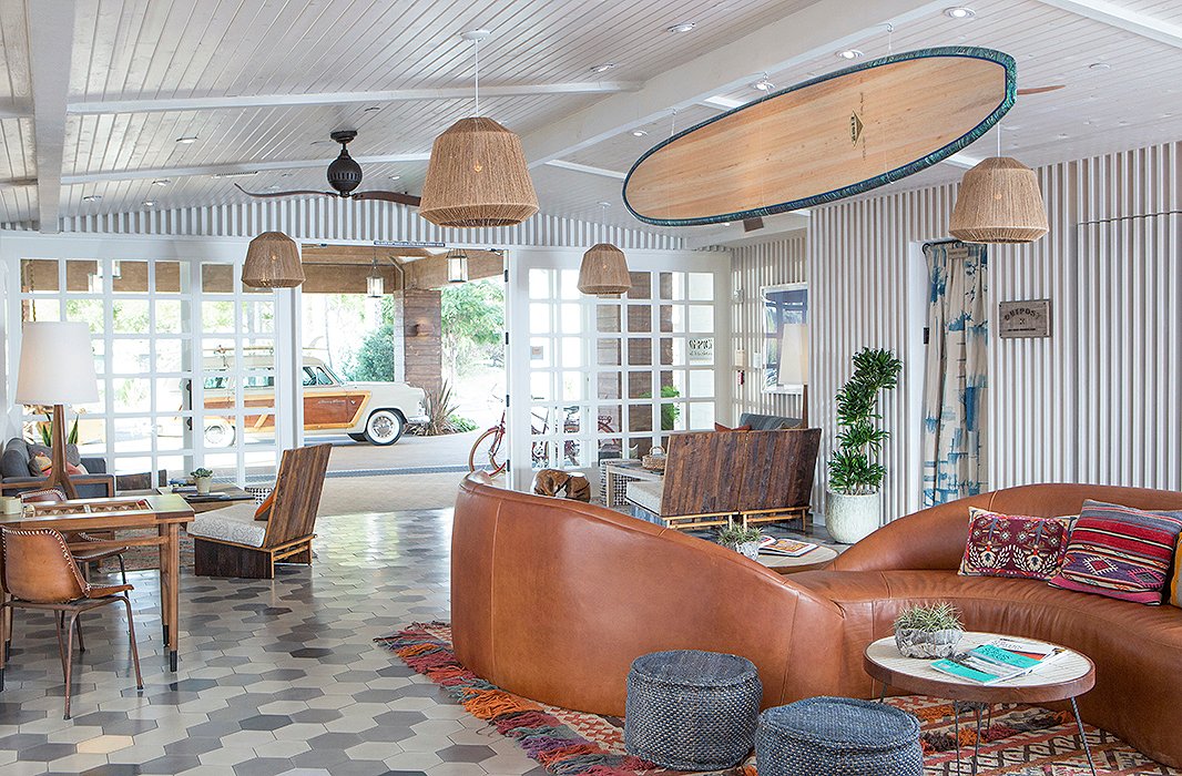 A surfboard hanging from the ceiling, a curved leather sofa… This is no ordinary hotel lobby. Find similar light pendants here. Photo courtesy of The Goodland.
