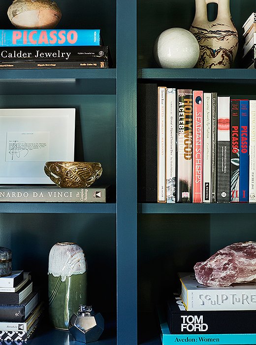 Painted Farrow & Ball’s Hague Blue but backed by the same Inchyra Blue as the walls, the built-in shelves in Jennifer’s office help corral her enviable collection of art books and pottery, interspersed with near-and-dear pictures of family, paintings by her adored artist grandmother, and other curios that invite a closer look.
