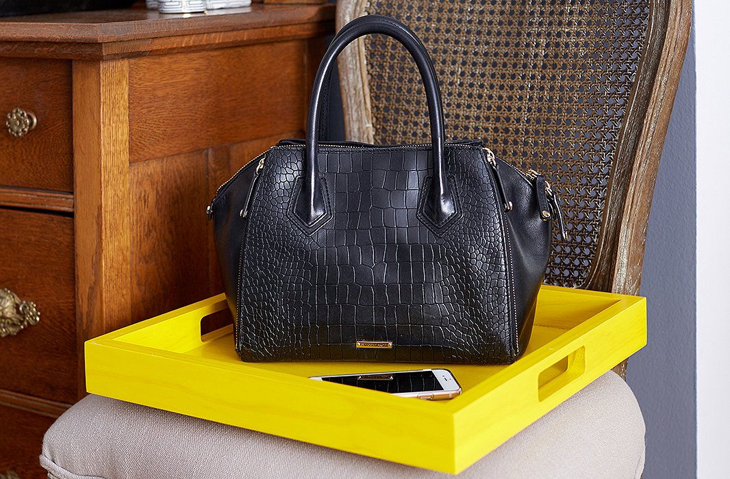 Just off the entry hall, a bright lacquered tray functions as a catchall and bag drop.
