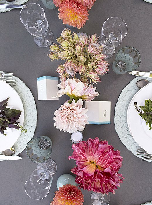 The centerpiece, running the length of the table, was made up of small blooms bursting with pinks and oranges. “Lately I have been loving using small vases with just a few flowers in them,” says Susan. “I love the simplicity, and they are low enough that it doesn’t deter a conversation across the table.”
