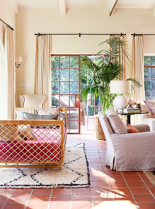 Nicole wrapped a daybed with raffia and anchored it with a Moroccan rug. The pink upholstery is a fashion-inspired hue, which works perfectly with the Saltillo tile floors.
