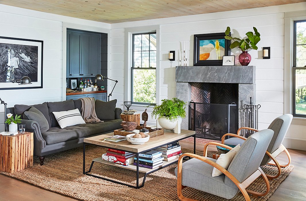 A gray linen sofa and pair of vintage Italian armchairs from Finch Hudson in Hudson, NY, create an inviting gathering spot by the fireplace. On the bluestone mantel, a small finger painting by T.R.’s niece rests alongside another titled The Bather. You can find the coffee table here.
