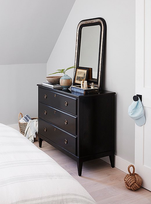 An antique mirror adds weight and character to a dresser designed by One Kings Lane.
 
