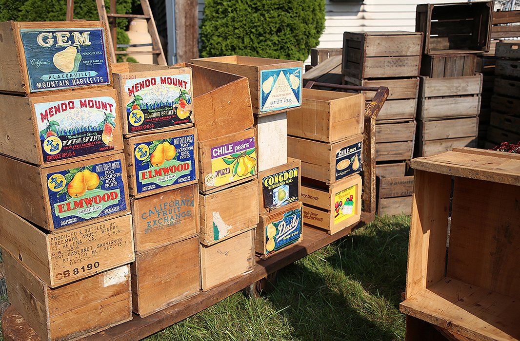 Vintage storage and packaging items, such as Coca-Cola crates, woven baskets, and boxes for transporting fruit, are a common sight at the show. 
