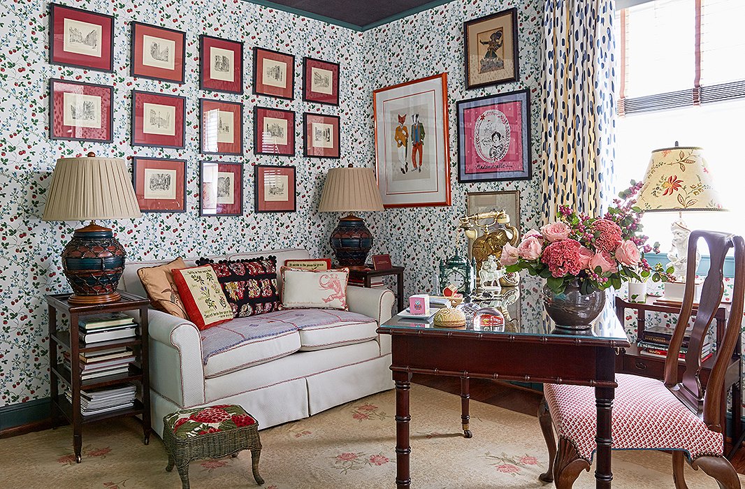 Coordinating artwork in matching frames and mats makes a graphic statement—even on top of heavily patterned wallpaper. Photo by Tony Vu.
