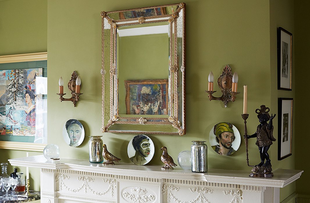 Sheila’s collection of Venetian glass includes this mirror, accompanied by a series of John Derian plates. Another dining room wall features a set of Hermès plates.
