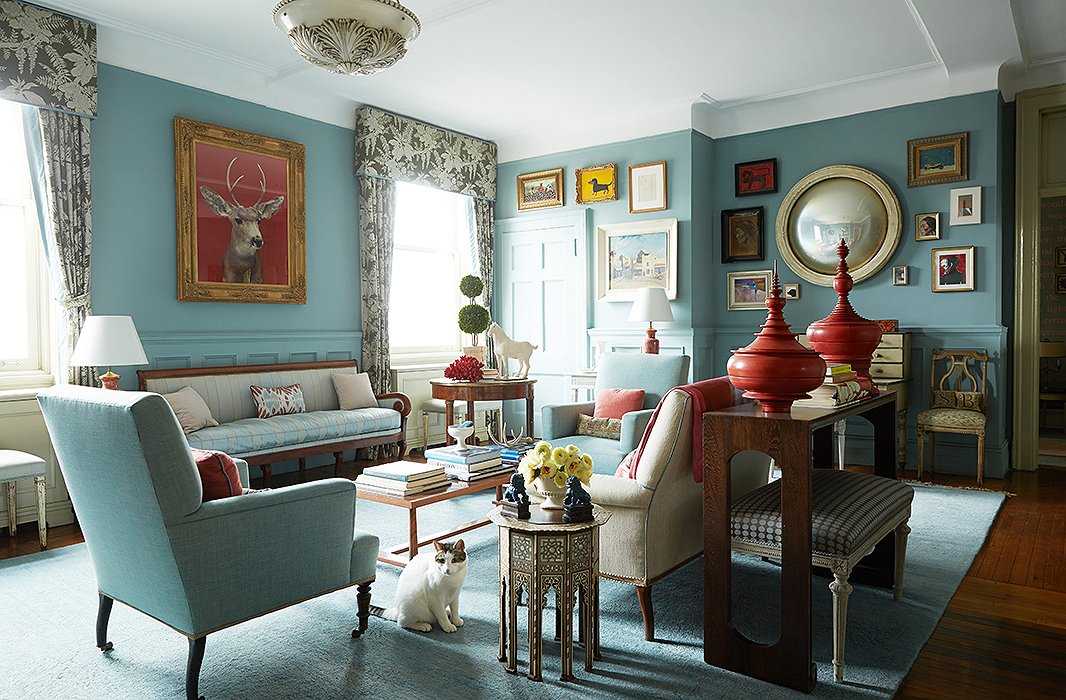 While the living room’s layout is high traditionalism, with a formal seating arrangement complete with silk-upholstered sofa, Sheila has woven in pieces from her travels such as red lacquered Burmese offering vessels and an inlaid Moroccan table.
