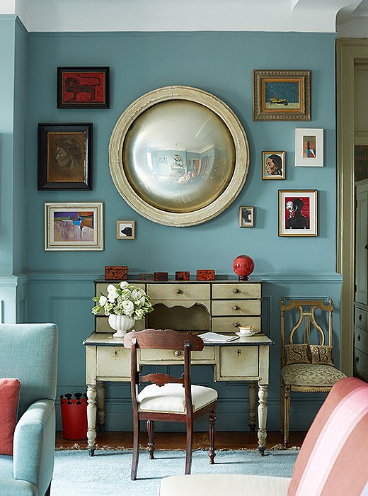 An evolving salon wall of art surrounds a French mirror. “I have a fetish for convex mirrors,” Sheila says.
