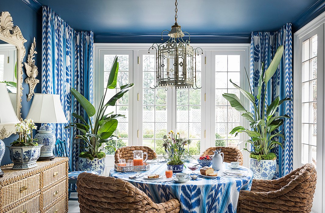 A true Mediterranean home probably wouldn’t be quite so boldly blue, but this room’s walls and ceilings definitely call to mind azure waters. The crisp white trim, the woven chairs, and the greenery contribute to this lively take on the style. Photo by Lesley Unruh; room design by Danielle Rollins.

