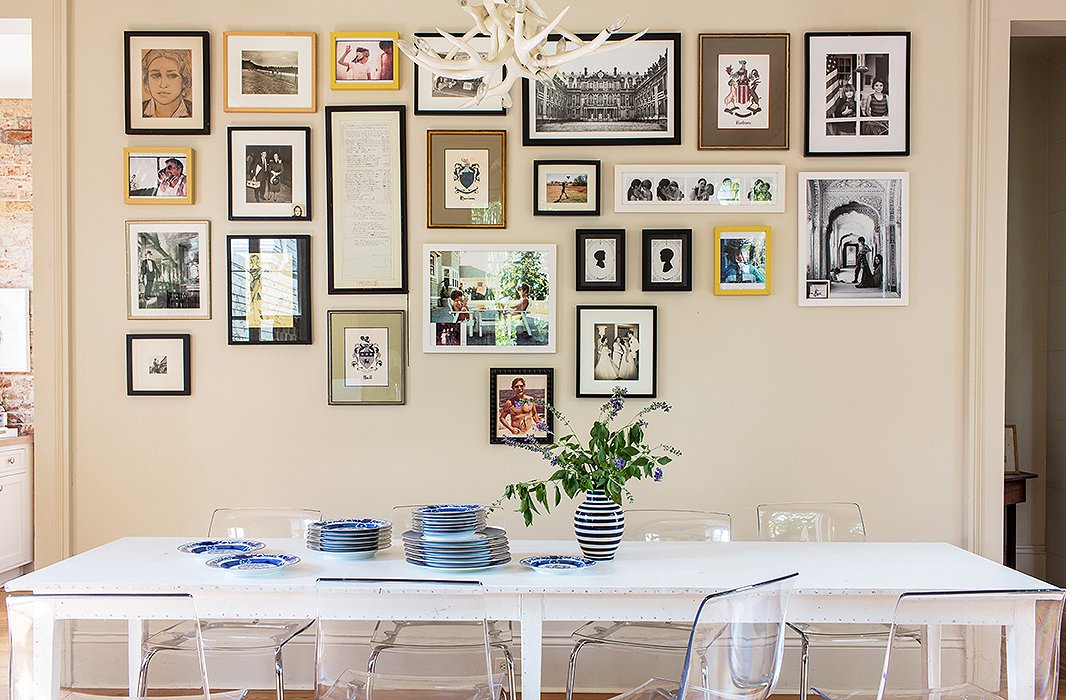 The gallery wall gets a modern update thanks to the alignment of works at the top of the arrangement. Photo by Nicole LaMotte.
