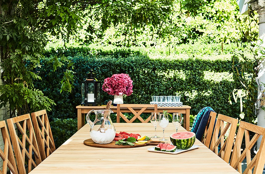 Beneath a pergola designed by Kaling’s father, Avu, sits another table surrounded by chairs backed with an updated chippendale motif. A console anchors the far end, serving as a bar or buffet alfresco. 

