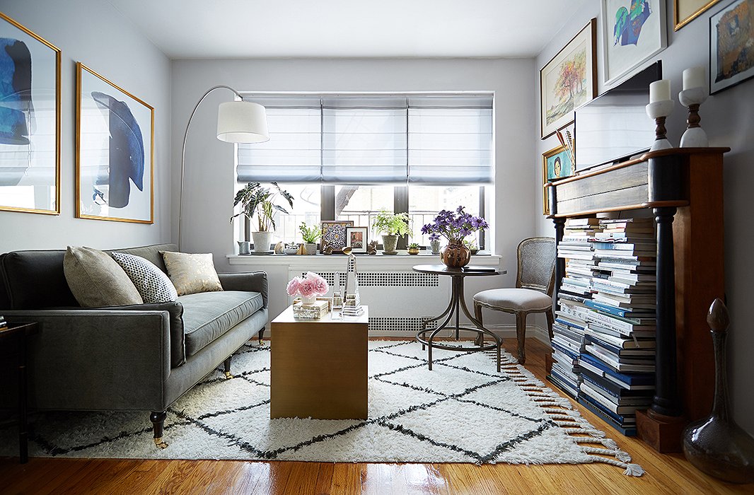 By simply adding a table and a chair in the corner, large-scale art, and a tall decorative mantel for books and the TV, Anthony reimagines the living area as a warm multipurpose spot with ample lighting and seating.
