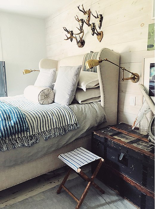 The bedroom is awash in airy neutrals, with hints of coastal blue and green. The layered bedding—including two lightweight blankets in indigo stripes—feels inviting and relaxed. “In Tulum, I discovered I loved blue and indigo, and I keep a lot of textiles thrown around,” says Dean.
