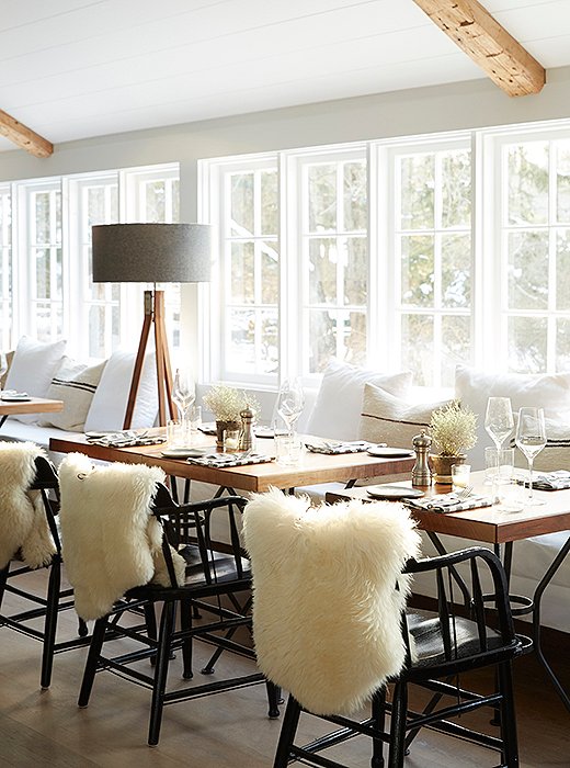 Sheepskins add softness to the glossy dining chairs, painted to achieve a lacquerlike effect.

