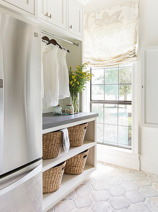 The laundry room doubles as a mudroom, with plenty of storage to accommodate a growing family. Photo by Julie Soefer.
