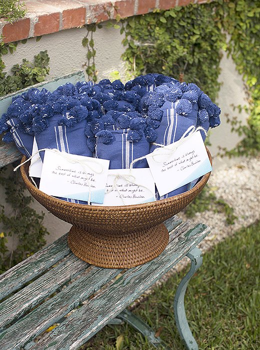 Susan filled a basket with bundled-up light blankets, both in case guests became chilly as the night carried on and as a parting gift for them to bring home. Attached with a quote from author Charles Bowden—“Summertime is always the best of what might be”—each was a charming ode to the season.
