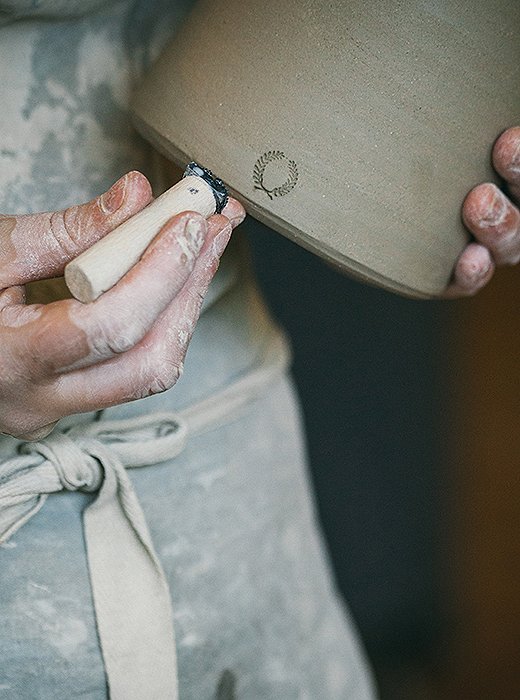 Farmhouse Pottery’s emblem is hand-stamped onto each piece. 
