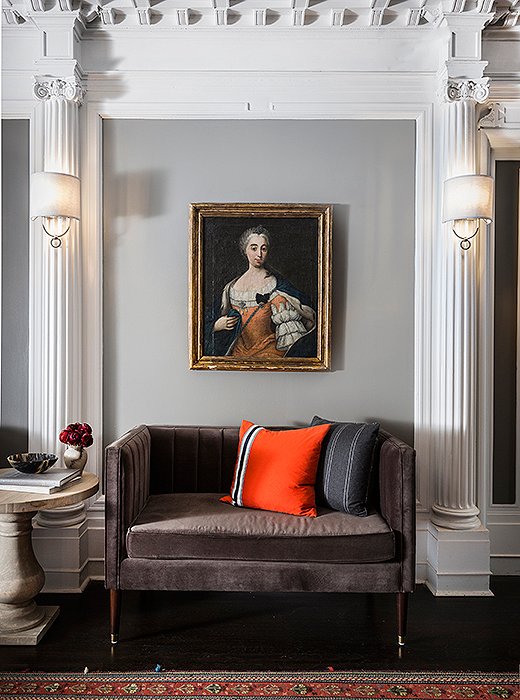 Plush velvet settees with channeled seams provide extra seating in the lobby.

