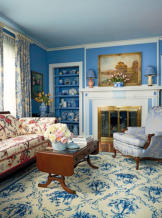 A shade of blue lends a sense of unity to a richly layered living room.
