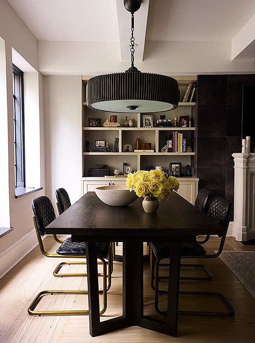 The dining room table is surrounded by quilted leather chairs. “I am obsessed with the chairs,” says Suki. “If you could ever call furniture sexy, it would be these. Sitting in them is like throwing on your favorite leather jacket. They go with anything and get more comfortable each time we use them.”  
