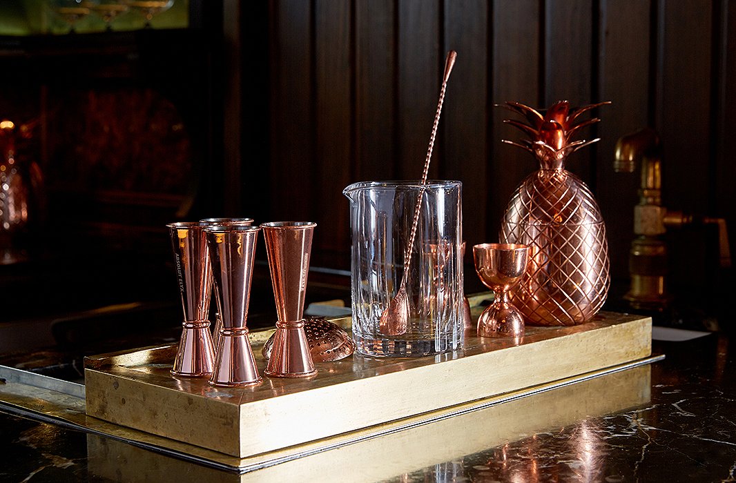Copper tools stand at the ready on Greydon House’s sprawling bar, a wood-paneled wonder salvaged from the Midwest and topped with honed marble. Like many other Greydon House details, the pineapple shaker nods to Nantucket’s whaling days, when sea captains displayed the tropical fruit as a symbol of welcome upon their return from far-flung voyages.
 
