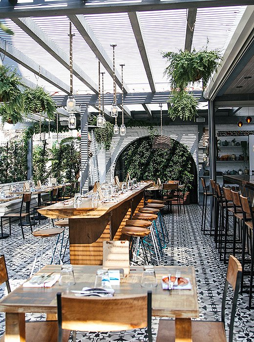 The Outpost has an airy indoor-outdoor vibe, with arched doorways and plenty of lush greenery. Photo courtesy of The Outpost.
