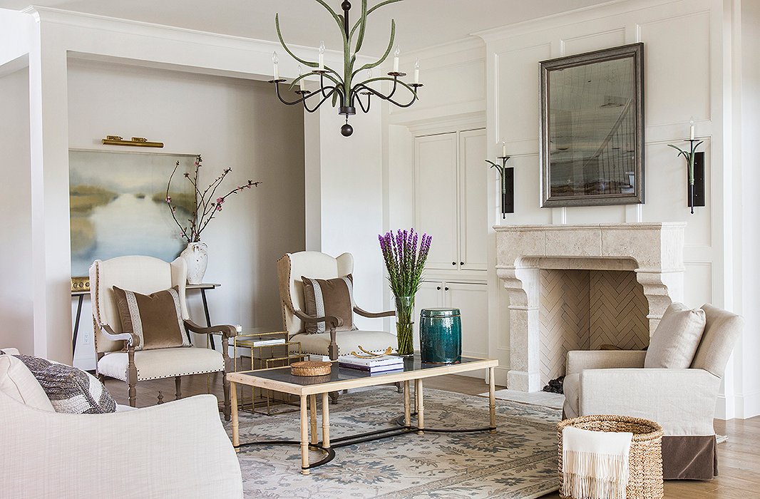A new stone mantel turned the fireplace into a stunning focal point for the living room, which was dressed in soft tones of brown and blue. Marie’s firm worked with The LaRocque Group on the remodel. Photo by Julie Soefer.
