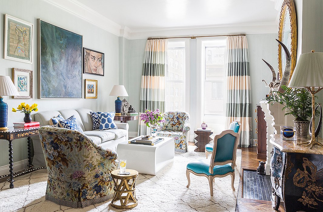 In the living room, CeCe aimed to emphasize the apartment’s connection to the green space nearby. “We have this beautiful view of the treetops because we’re on the fourth floor and of the skyline because all the buildings around us are low.” An airy blue wall color (a custom-mixed French strié) helps blur the boundaries between indoors and out, and curtains with a broad horizontal stripe visually widen the narrow windows.
