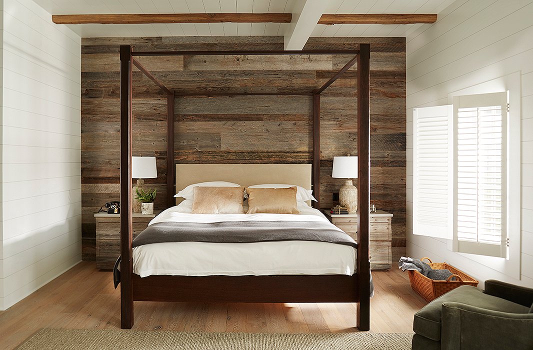 Bedrooms feature walls covered in shiplap and reclaimed wood along with king-size canopy beds and side tables crafted by local artisans. Rotary phones provide a nod to the past.
