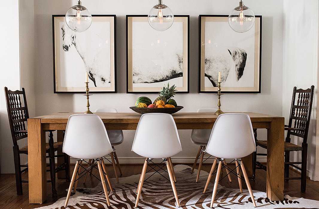 In the dining room, Paula paired two antique chairs that belonged to her mother with a set of midcentury-style seats. Find similar rugs here.


