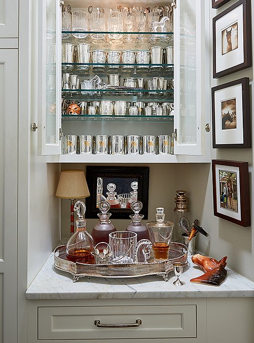 Off the living room is a closet complete with a bar just for bourbon. Silver sipping cups and crystal tumblers above decanters of Maker’s Mark and Bulleit glisten when lit. “It certainly makes getting dressed a whole lot more fun,” laughs Jon. 
