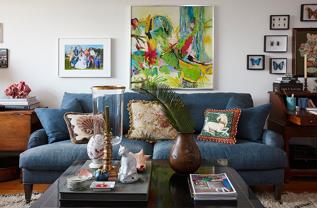 For Bobby, “finding the right sofa is like finding that sweater you know you’ll have for years—you have to love it.” Here, the couple’s indigo sofa anchors an eclectic collection of art, including a painting by Bobby’s great-aunt and a photograph from Staley-Wise Gallery, where Matt held his first job.
