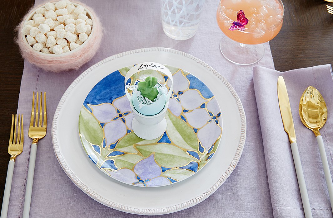 Dylan’s Easter table includes pastel linens for a fresh, airy vibe, along with sparkling glassware and dishes in springtime motifs.
