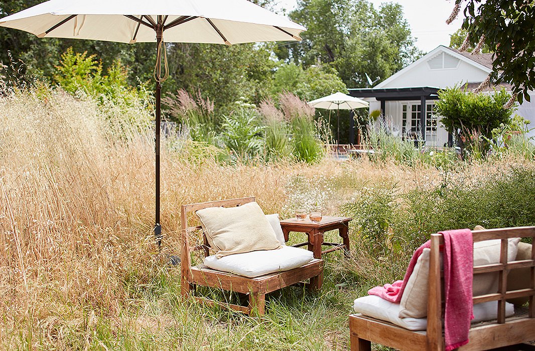 Beyond the deck is the garden filled with artichokes, sage, lavender, and miscanthus. “When we moved here from the East Coast, I knew nothing about how to address the plants that were here,” says Laura, “so we let it all grow wild, and I love it. Each day I find myself becoming more and more connected with the landscape.”
