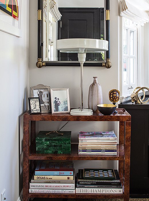 A burlwood tea cart filled with books and topped with a metal lamp anchors one corner of Marlien Rentmeester’s Los Angeles home office. Photo by Lesley Unruh.
